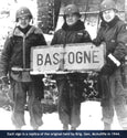 Gen. McAuliffe holding Bastogne 1944 sign