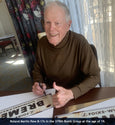 B-17 pilot Roland Martin autographs Masters of the Air Bremen signs