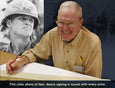 Hal Moore autographs the prints