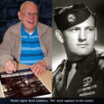 Paratrooper Buck Compton autographs a poster