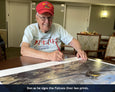 Iwo Jima Marine Don Whipple signs the art prints